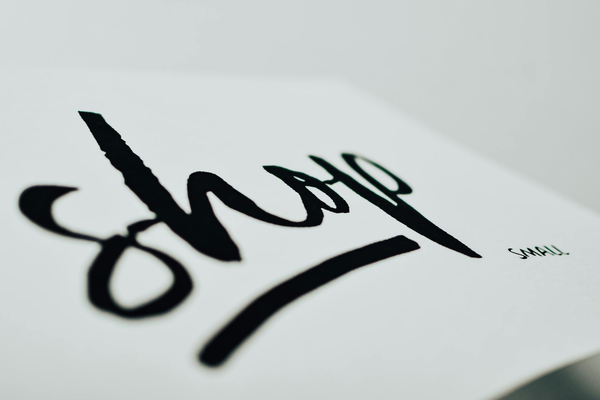 Close-up of a handwritten sign promoting support for small businesses.